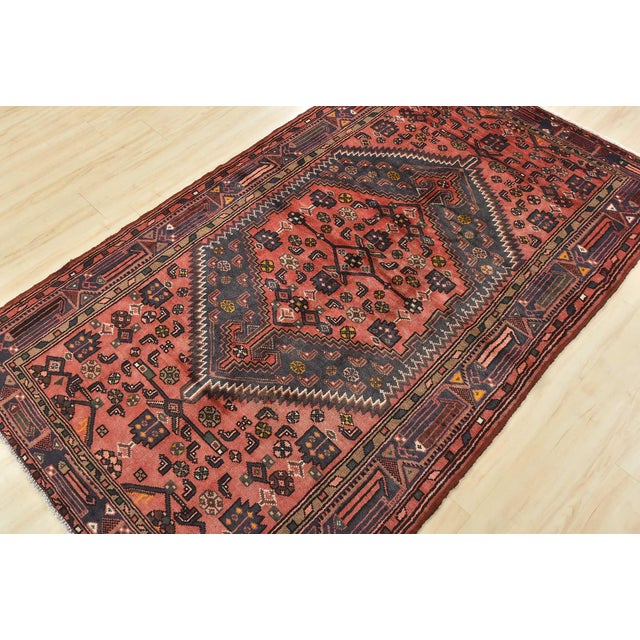 An authentic vintage tribal Hamedan rug hand-knotted with fine wool and natural dyes. This nomadic oriental rug features a...