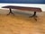This is a classic traditional banded mahogany dining table by Leighton Hall. It features an understated field of cathedral...
