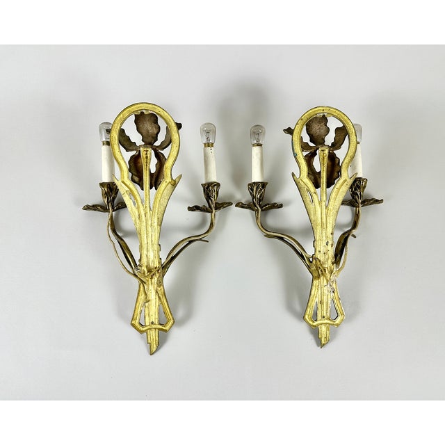 Breathtaking antique bronze wall sconces. Hailing from France and dating to the turn of the 20th century (circa 1900),...