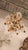 This listing features a champagne, orange, and clear crystal chandelier that most likely originated from France in the...