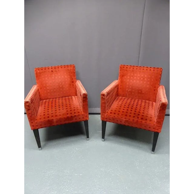 Pair of red velvet armchairs with blackened wooden legs with chrome hooves, 20th century. I have official proof of...