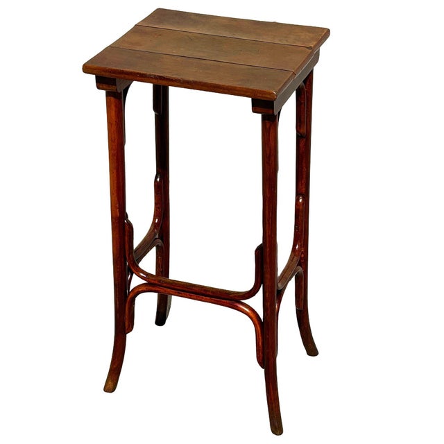 Turn of the century Thonet Short Size Nestng side table features an elegant, sculptural frame crafted from warm-toned...
