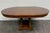 This is a vintage Neoclassical Regency Revival walnut pedestal dining table featuring a beautifully figured walnut veneer...