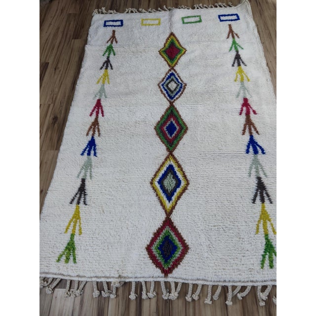 One-of-a-kind handwoven Azilal rug from Morocco. An ivory ground scattered with whimsical multicolor arrow motifs in...