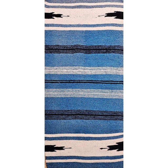 This Vintage American Southwestern Area Rug showcases a striking and exceptionally rare Persian blue ground, distinguished...