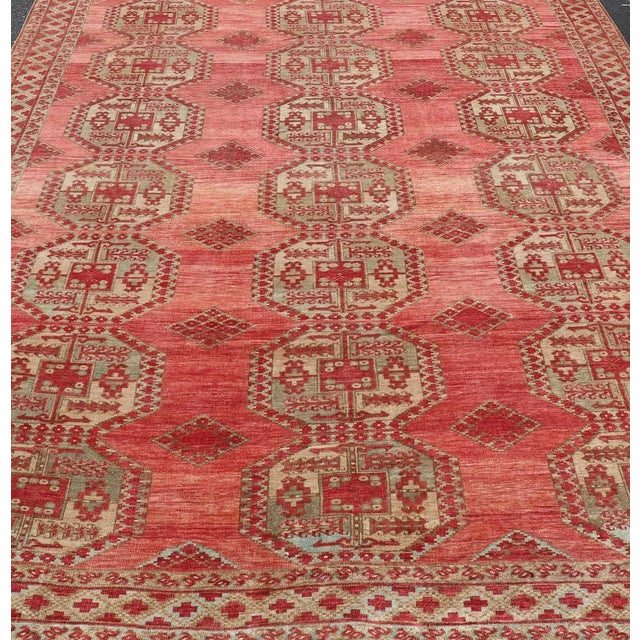 Antique Turkomen Ersari rug with Repeating Gul Design in soft red background, green, light blue, butter yellow. Hand-...