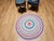 A charming and colorful antique American braided round rug from the second quarter of the 20th century, circa 1940s,...