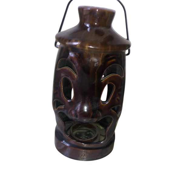 Beautiful drip glaze teacup candle holder lantern with metal arched handle or hanger. Kind of comical …a little Tiki-ish...