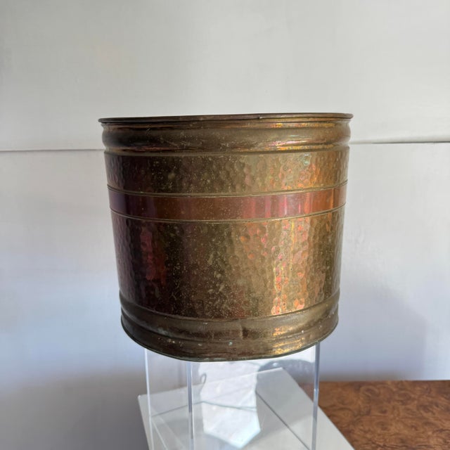 Brass wastebasket or planter with copper band, with hammered finish. Shows signs of age. A rich patina. Some verdigris.