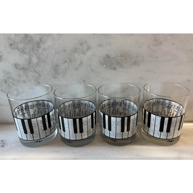 Set of 4 vintage lowball glasses with piano keys on the outside of the glass and music notes on this inside. Made by...