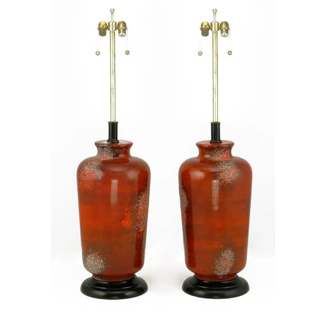 Unique table lamps look as though they were formed from molten lava. Deep textured red glaze over Vermillion ceramic vase...