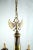 Beautiful eight-armed flemish chandelier made of patinated brass. The upper part of the chandelier is decorated with a...