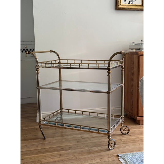 This antique bar cart holds attention in a room! The three tiers allow for ample storage and styling. The frame is...