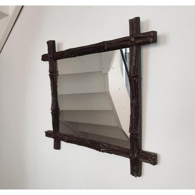 Mirror in wood carved to imitate wood made by frame and mirrormaker August Bergin & Co Stockholm. Jugend, late 1800s....