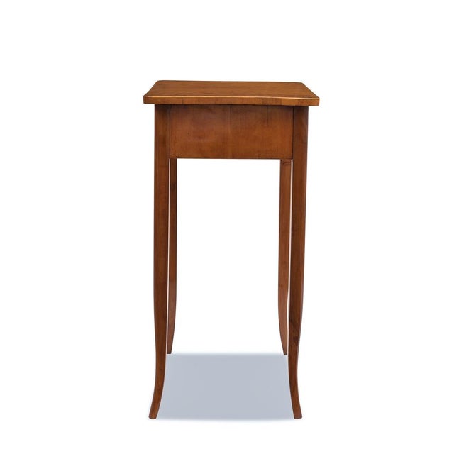 This Biedermeier side table, dating from around 1820, was crafted in Germany with a birch veneer. Its construction is...