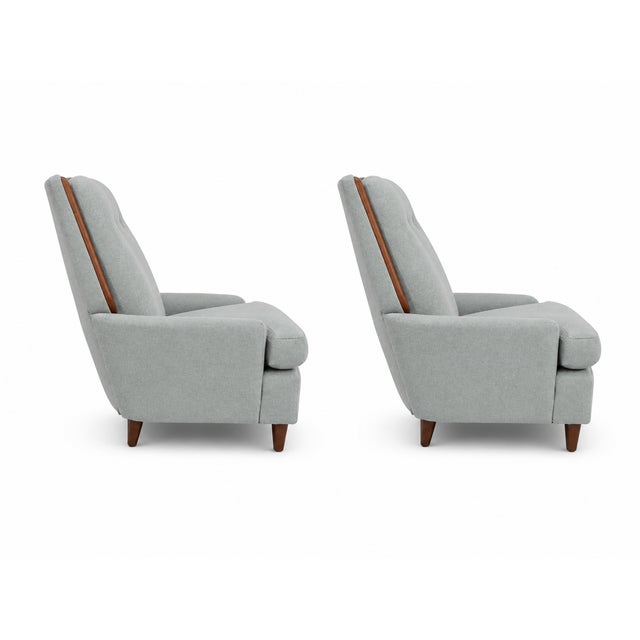 Modern mid century lounge chairs. The chairs were upholstered by our shop in a sea foam green chenille. The walnut wood...