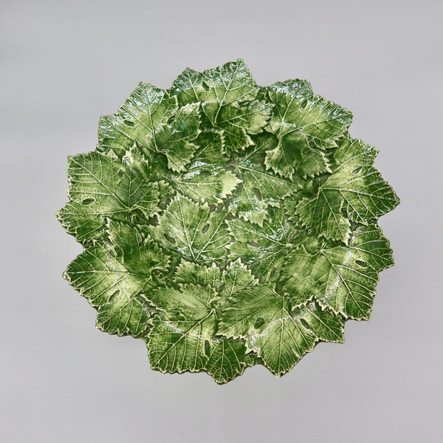 A vintage majolica compote bowl made in Italy, faintly marked "Bassano" on the underside, hand-molded in an overlapping...