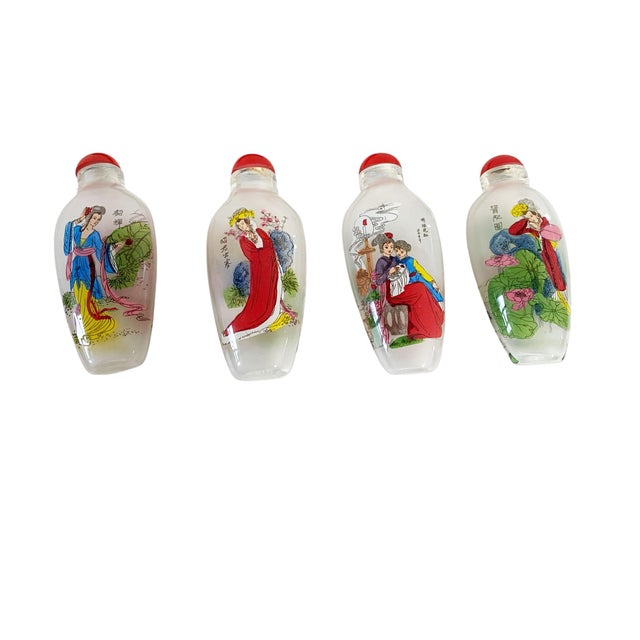 Set of four vintage peking glass snuff bottles in a box depicting female figures with flowers birds etc.. Red glass...