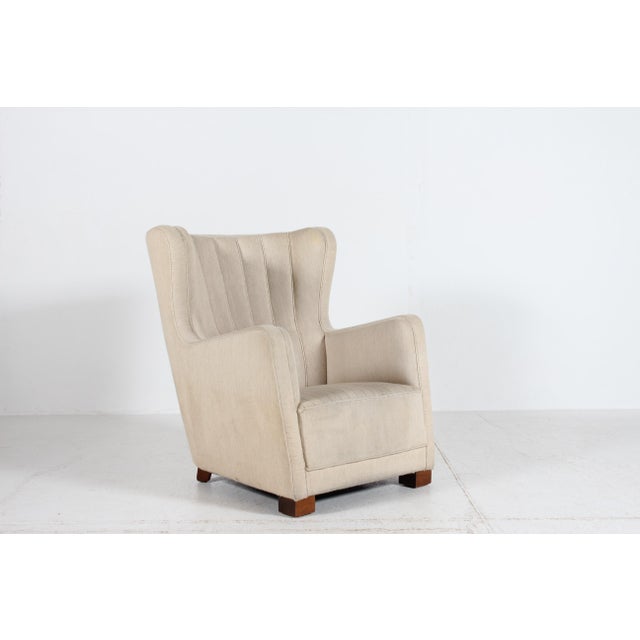 Large impressive and comfortable Fritz Hansen style Danish Art Deco lounge chair made in the 1930s. It's upholstered with...