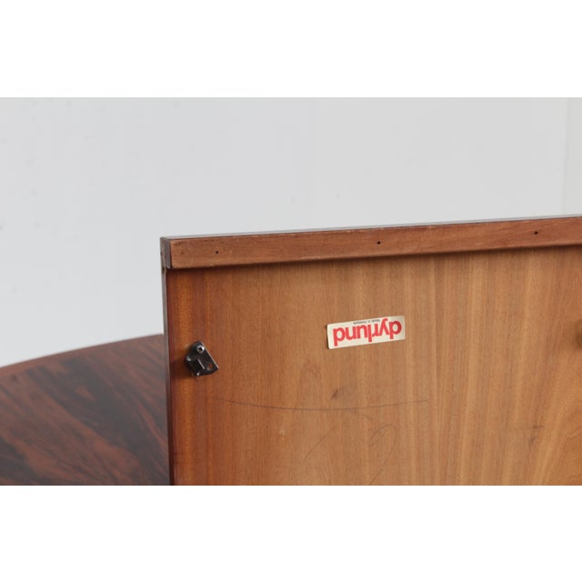 Vintage Danish oval extendable dining table from the 1960s designed by Dyrlund made of palissander veneer wood. This...