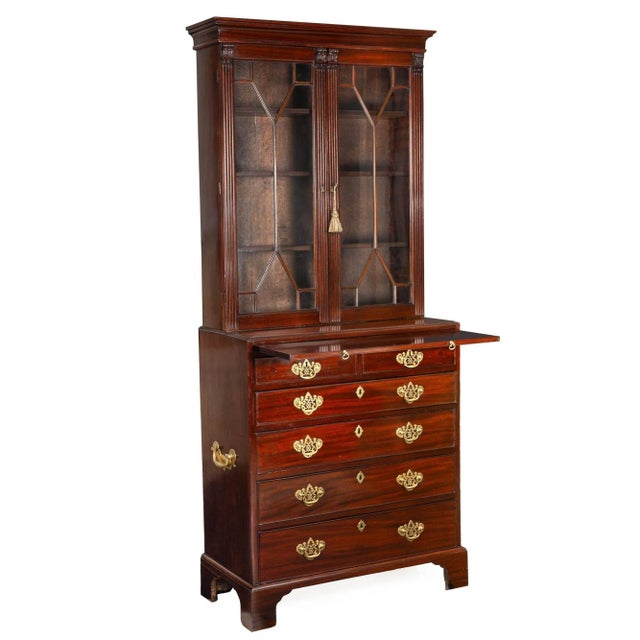 A very fine secretary desk of diminutive proportions, this fabulous form features an upper bookcase with a cove-molded...