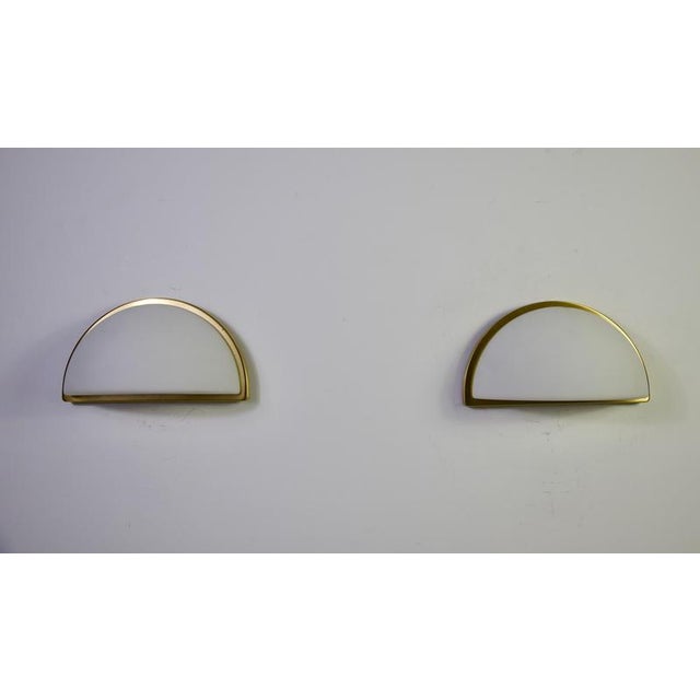 Pair of brass and opal glass wall lamps by peill & putzler, germany, 1970s. This elegant pair of vintage wall lights...