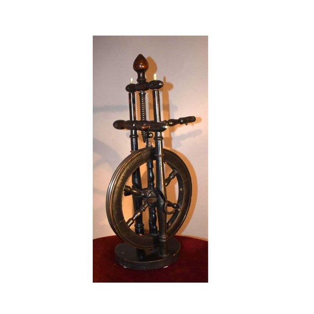 An unusual small spinning wheel in original paint with bone turned details. It's really a lovely example of the turner's...