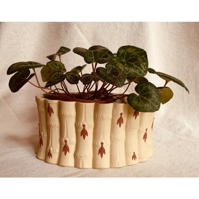 A truly special piece of early 20th century caneware with primrose terracotta decorative leaves. This color, style and...