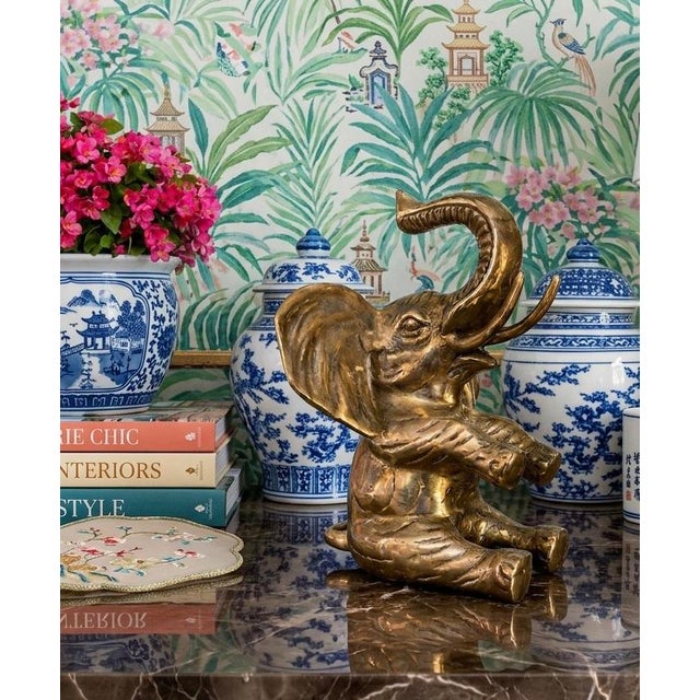 Add a touch of Palm Beach Regency charm to your décor with this beautifully cast vintage solid brass sitting elephant,...