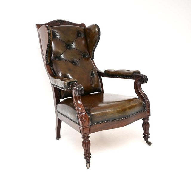 An exceptional antique William IV Leather and Walnut wing back armchair. This is possibly Irish or English, it dates from...