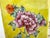 A vibrant vintage porcelain table lamp featuring a richly saturated yellow ground adorned with delicate hand-painted...