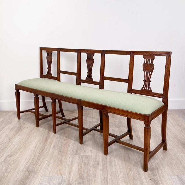 An Italian Neoclassical walnut settee. Antique elements.