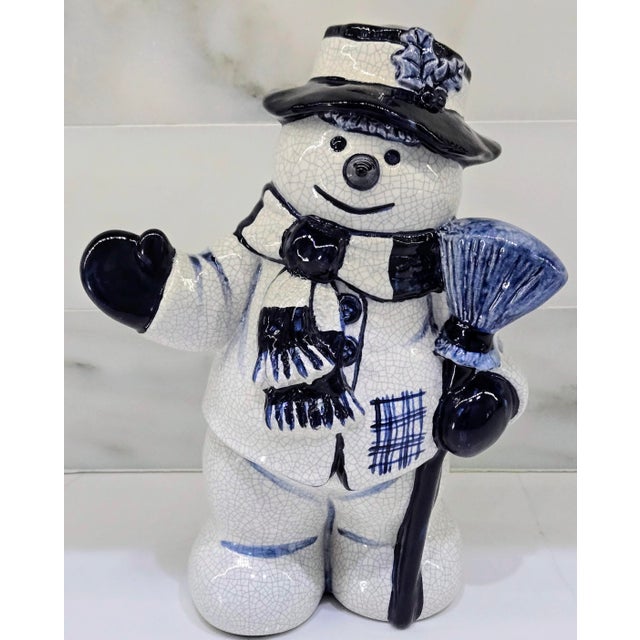 A wonderfully whimsical vintage blue-and-white crackleware snowman figurine, attributed to The Potting Shed and dated...