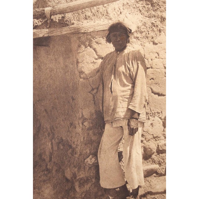 An original photogravure from Edward S. Curtis's The North American Indian. A Santa Ana Man is a full-length portrait of a...
