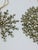 A dazzling pair of vintage rhinestone ornaments featuring intricate openwork designs crafted from faceted clear glass...