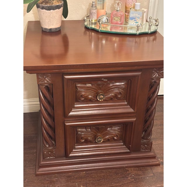 Beautiful traditional wood end table with two drawers and ornate carved details. Features decorative twisted columns,...