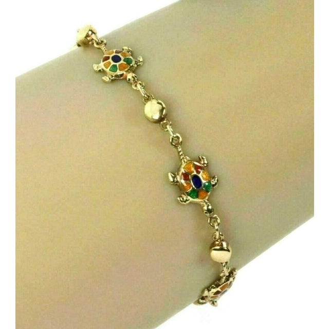 Crafted with an eye for elegance and a touch for whimsy, this Multi-Color Enamel Turtle 14k Yellow Gold Charms Bead...