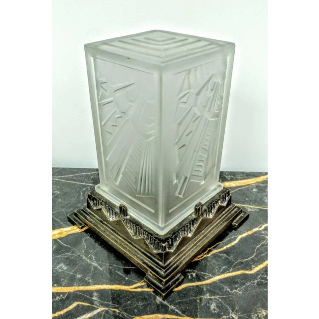 A French Art Deco table lamp created by French Master "Marius Ernest SABINO". The shade is enhanced by a typical flower...