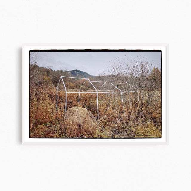This contemporary rural landscape photograph presents the fragile frame of an agricultural structure in Great Barrington,...