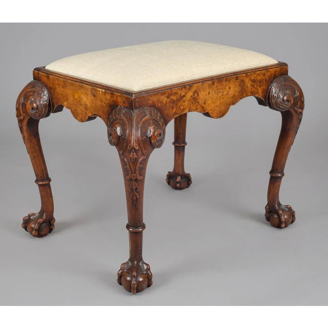 George I style walnut stool, the rectangular top with a slip-in seat above shaped burr walnut frieze, raised on cabriole...