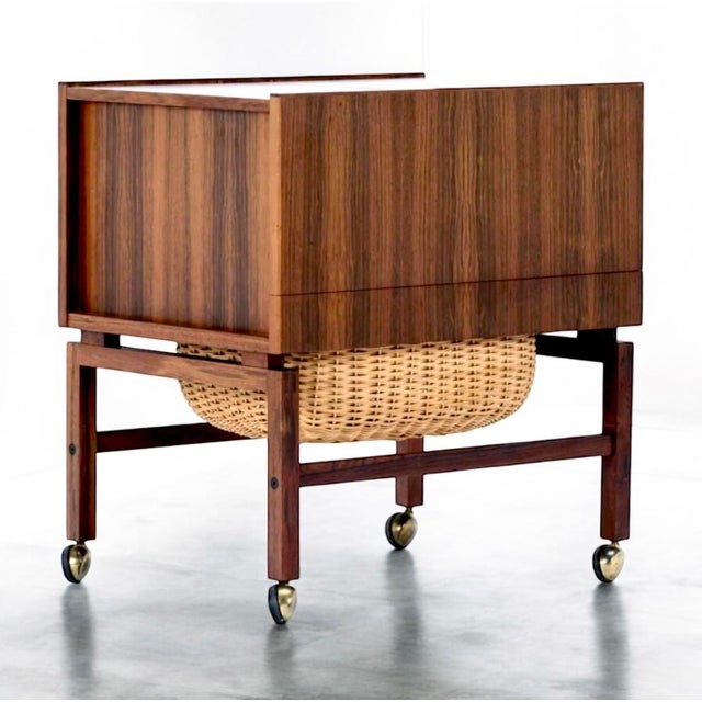 Danish sewing table attributed to erling torvits, produced in denmark during the 1960s. the piece is executed in rosewood...