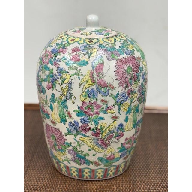 Design Plus Gallery presents a Famille Fleurs Porcelain Jar + Lid of Chinese Origin. Floral motifs, butterflies, and fruit...