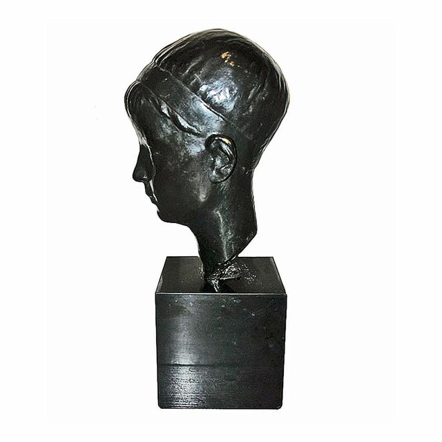 A bronze head of a youth in bronze with black patina, on a black marble pedestal, circa 1935. By Alexandre Wolkowyski,...