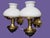 This pair of wall lamps combines softly rounded opal white glass shades with polished brass fittings in a design...