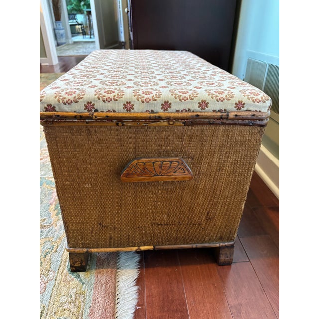 Tan colored reeded, rattan lift-top, hinged chest / trunk / storage bench with upholstered top. Wasteful as a decor item...