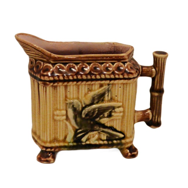 A Victorian Majolica teapot, circa 1890, featuring classic Aesthetic Movement faux-bamboo detailing. The body is styled as...
