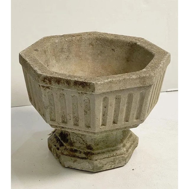 A fine pair of English octagonal garden urns or planter pots of composition stone - each planter featuring a relief design...