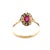 A delicate vintage ring crafted in 13K two-tone gold, showcasing an oval ruby center encircled by a shimmering diamond...
