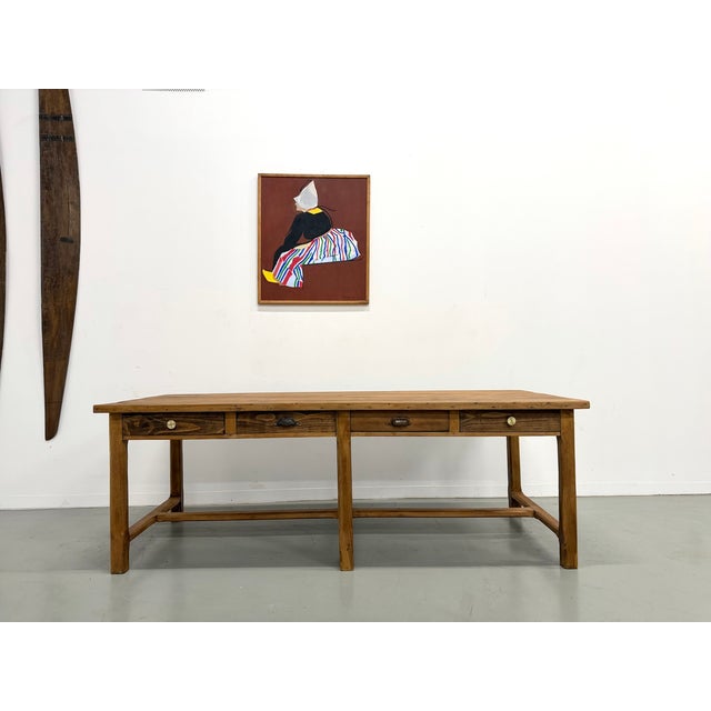 With its eight drawers and patinated solid pine top, this table offers spectacular storage capacity and an authentic feel....