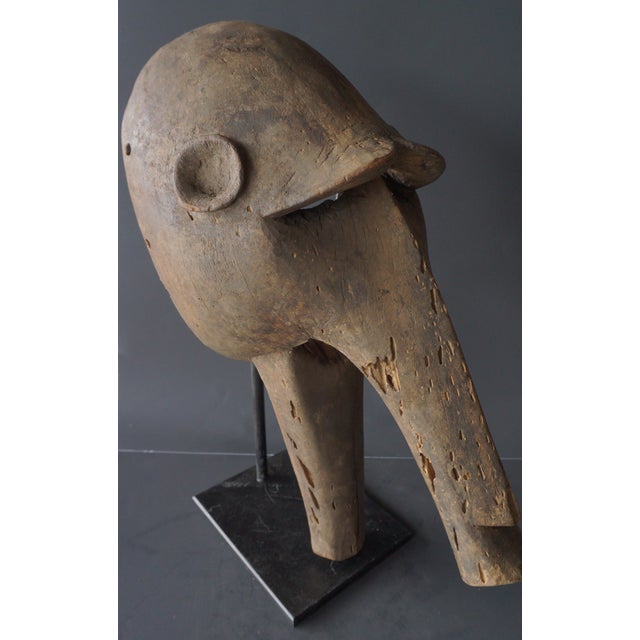 This is a traditional Dogon mask from Mali, West Africa. These masks are typically made of wood and used in rituals called...